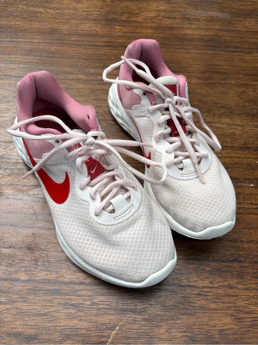 Nike Women's Light Pink Running Sneakers with Red Swoosh